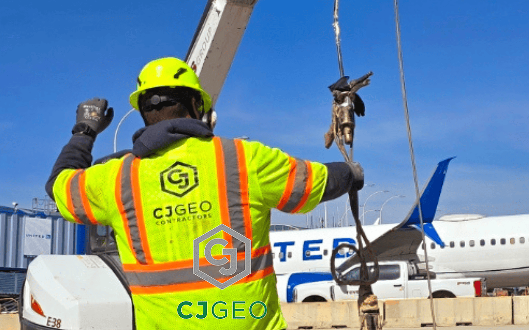 a CJGeo employee with a plane in the background at an airport construction project