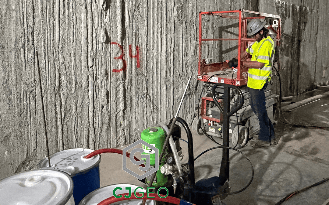 a worker, lift and grouting equipment inside a slurry wall basement
