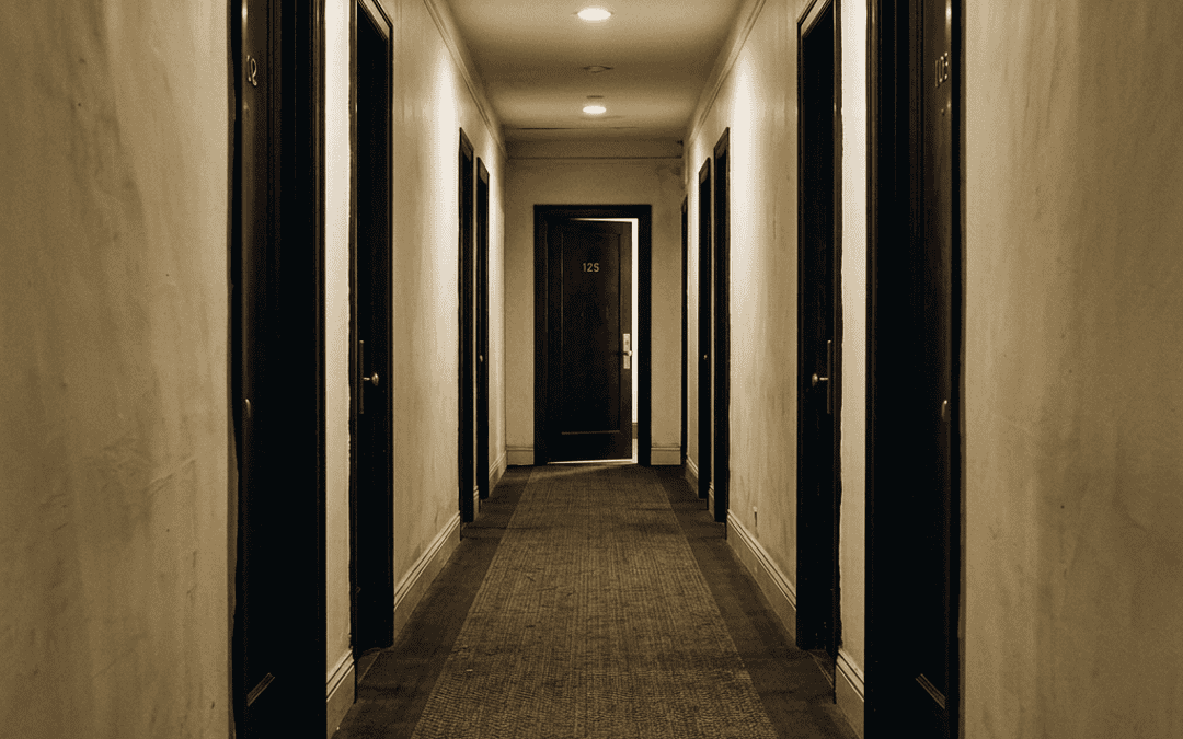Nearly closed door at corridor end