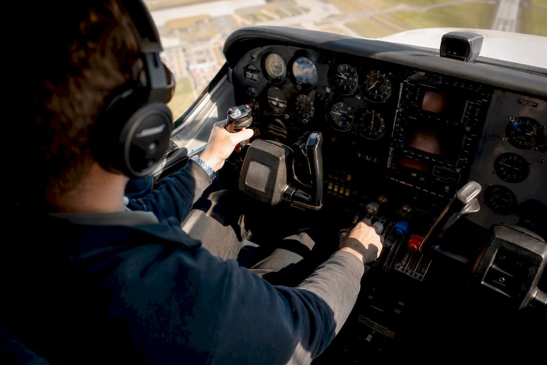 Pilot hands controlling multi-engine aircraft in flight