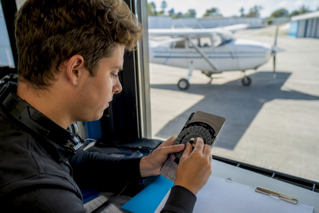 Pilot preparing for FAA checkride inside hangar