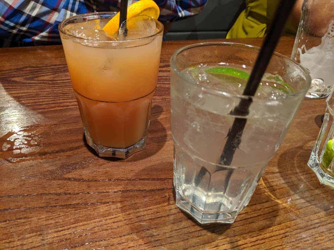 cocktails with fruit on a wooden table.