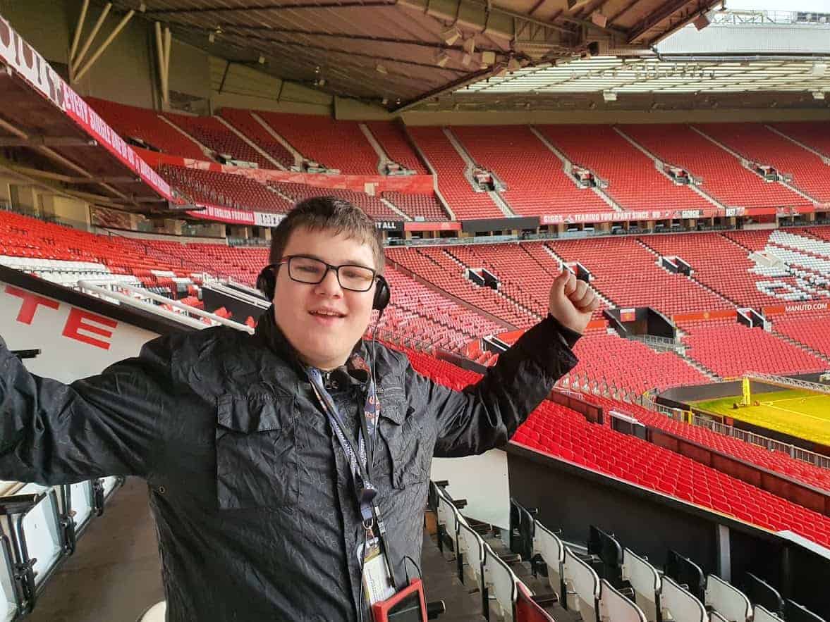 A smiling young boy at a football stadium