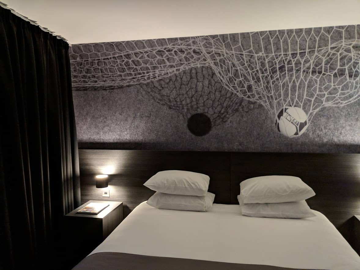 A large bed in a room with black and white decor