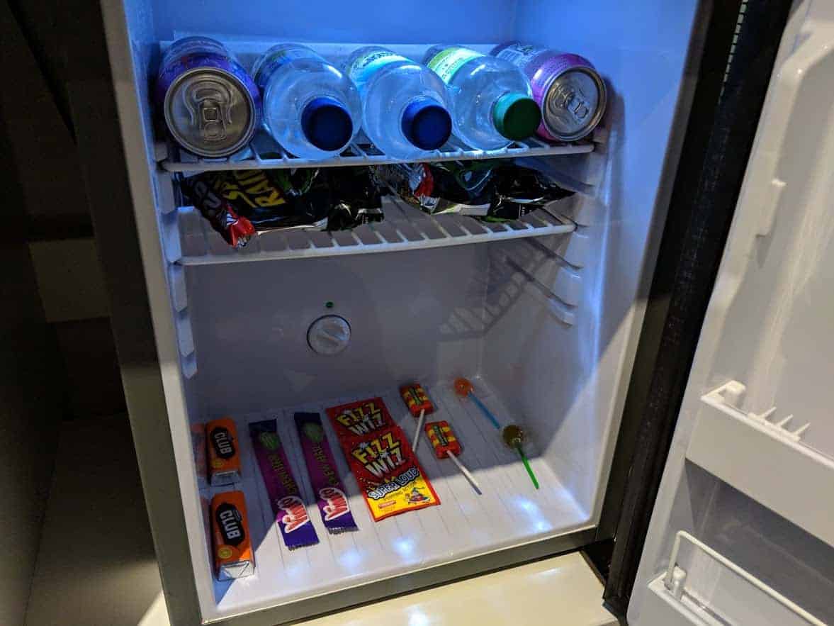 The interior of a mini fridge with snacks and drinks