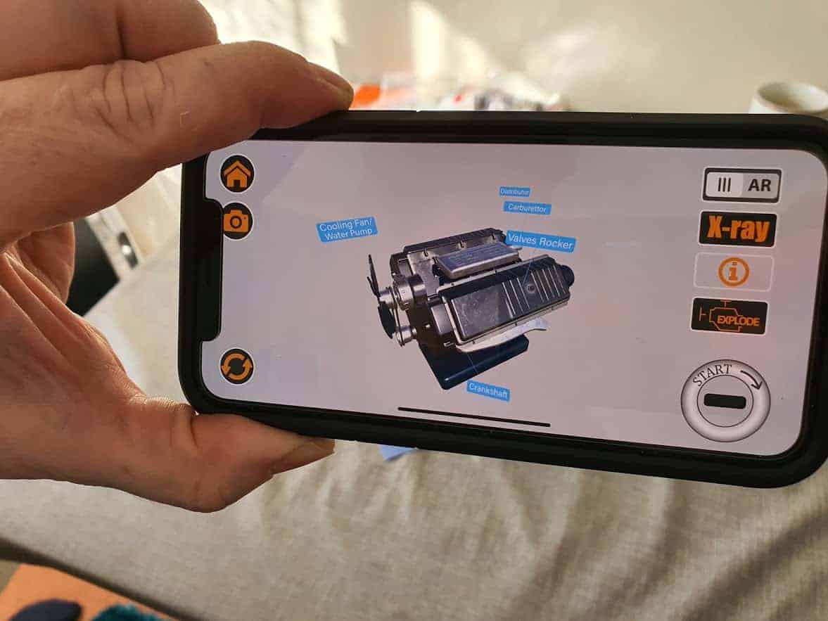 hand holding a phone showing v8 app