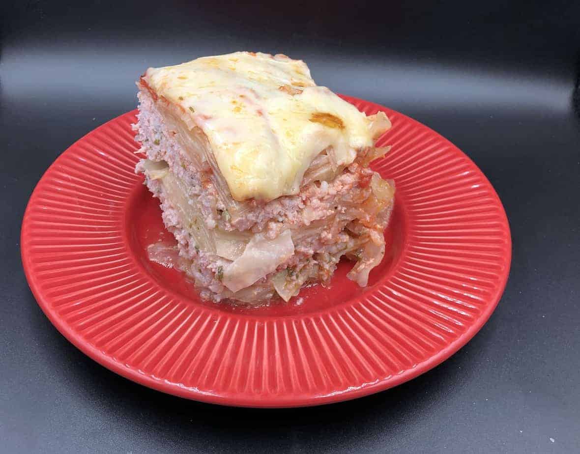 Polish lasagna in a red plate.