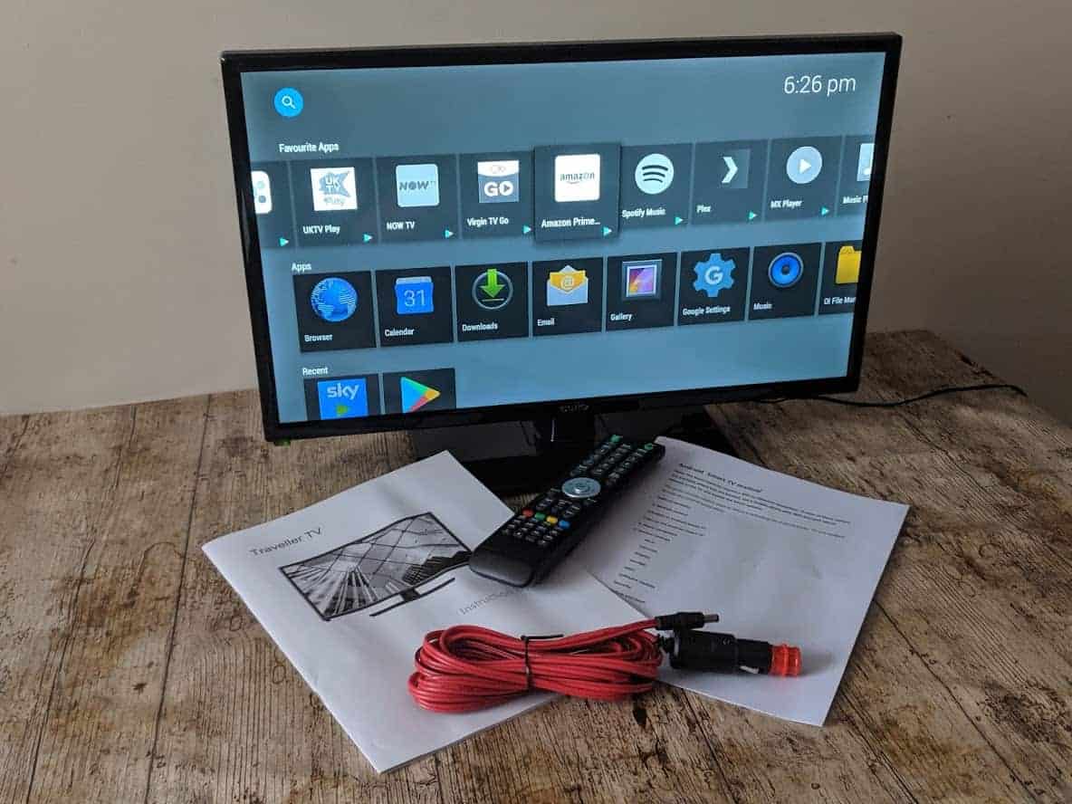 Cello 22" Traveller Smart Full HD TV on a wooden table with instruction booklets, cable and remote control