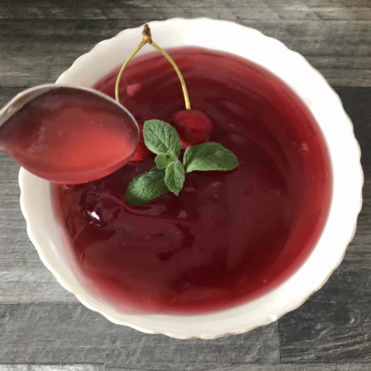 Kisiel jelly in a spoon over a white bowl.