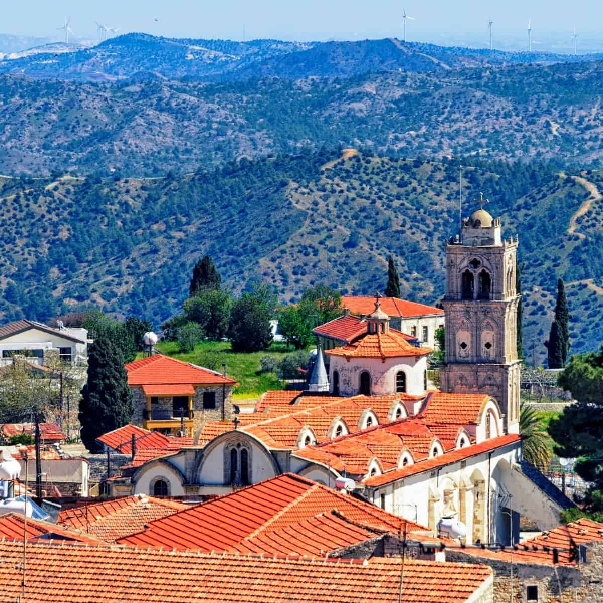 photo showing cyprus with a hilly background and a church in the forefront