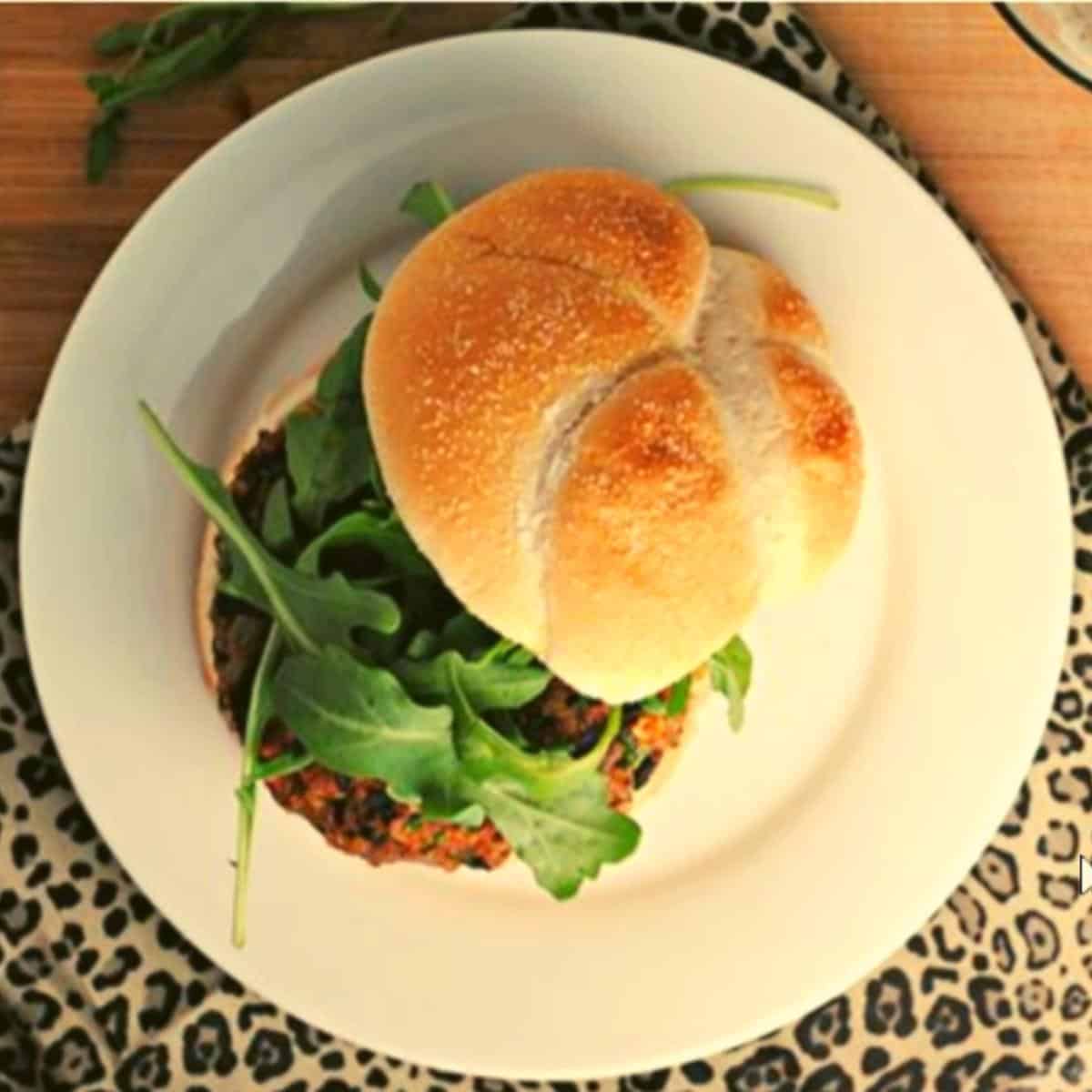 quinoa burger in white bun with salad