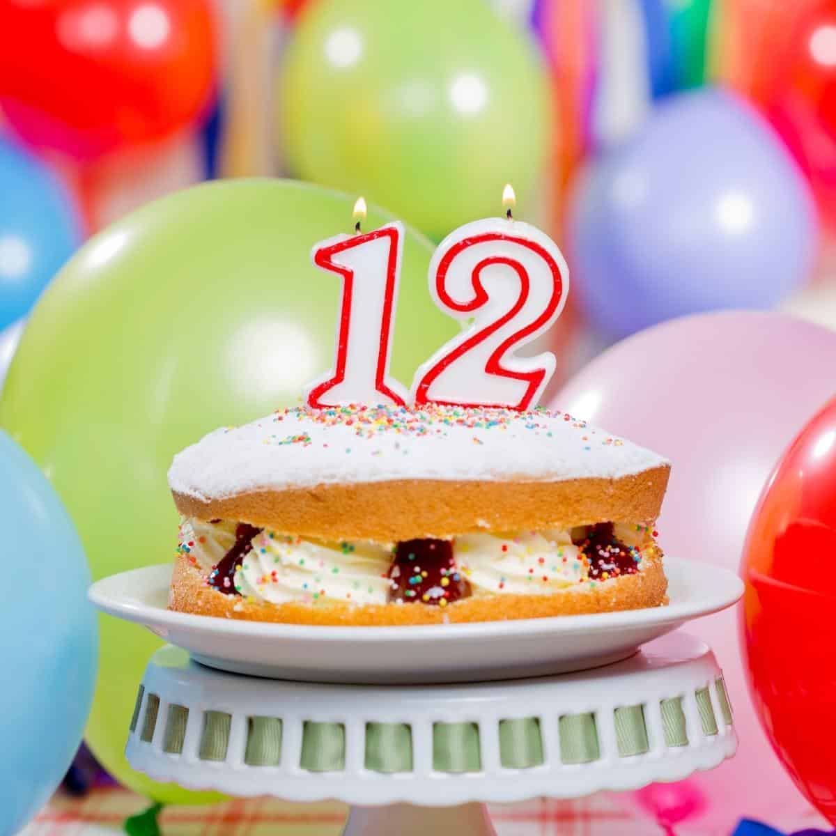 12th birthday cake surrounded by balloons
