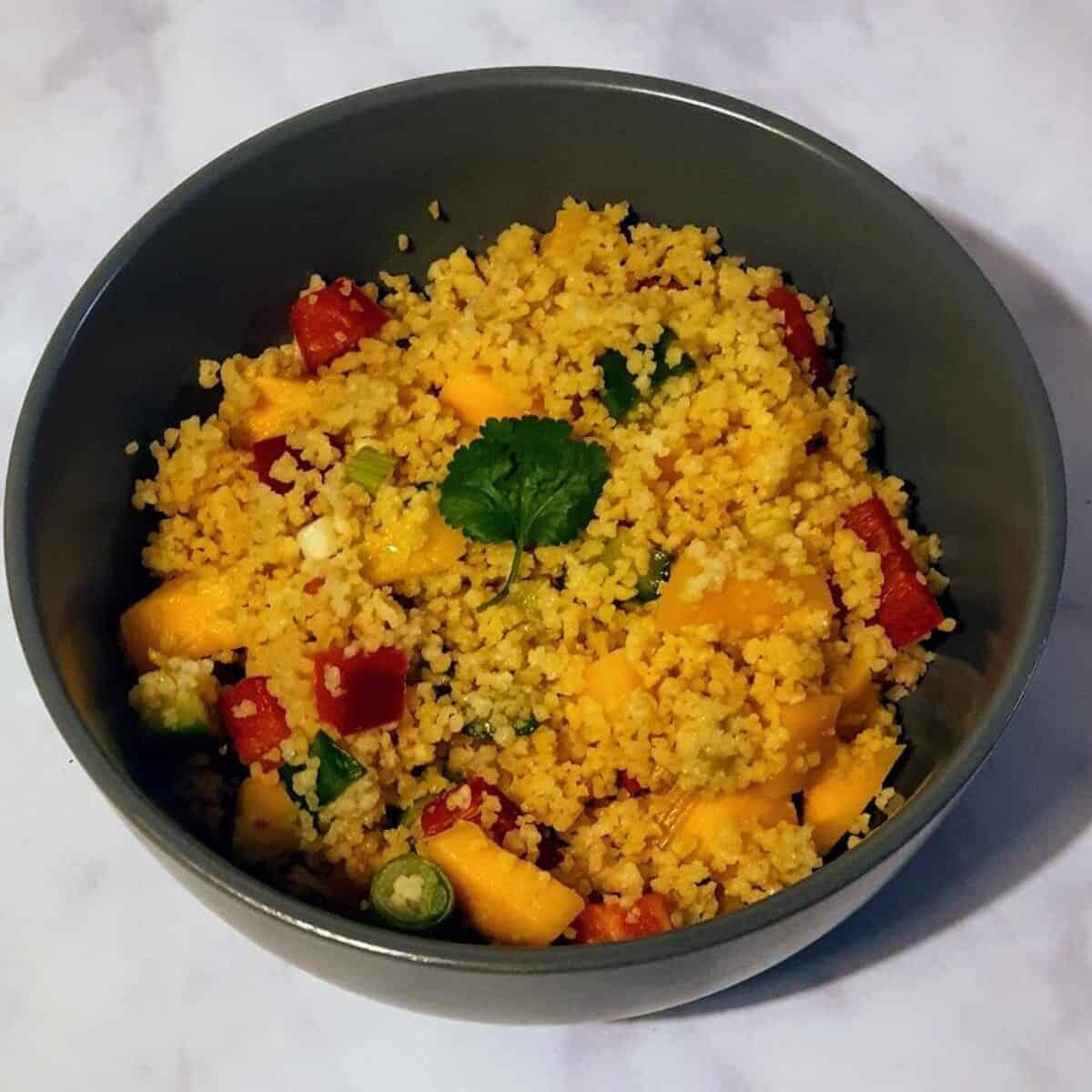 grey bowl of mango couscous