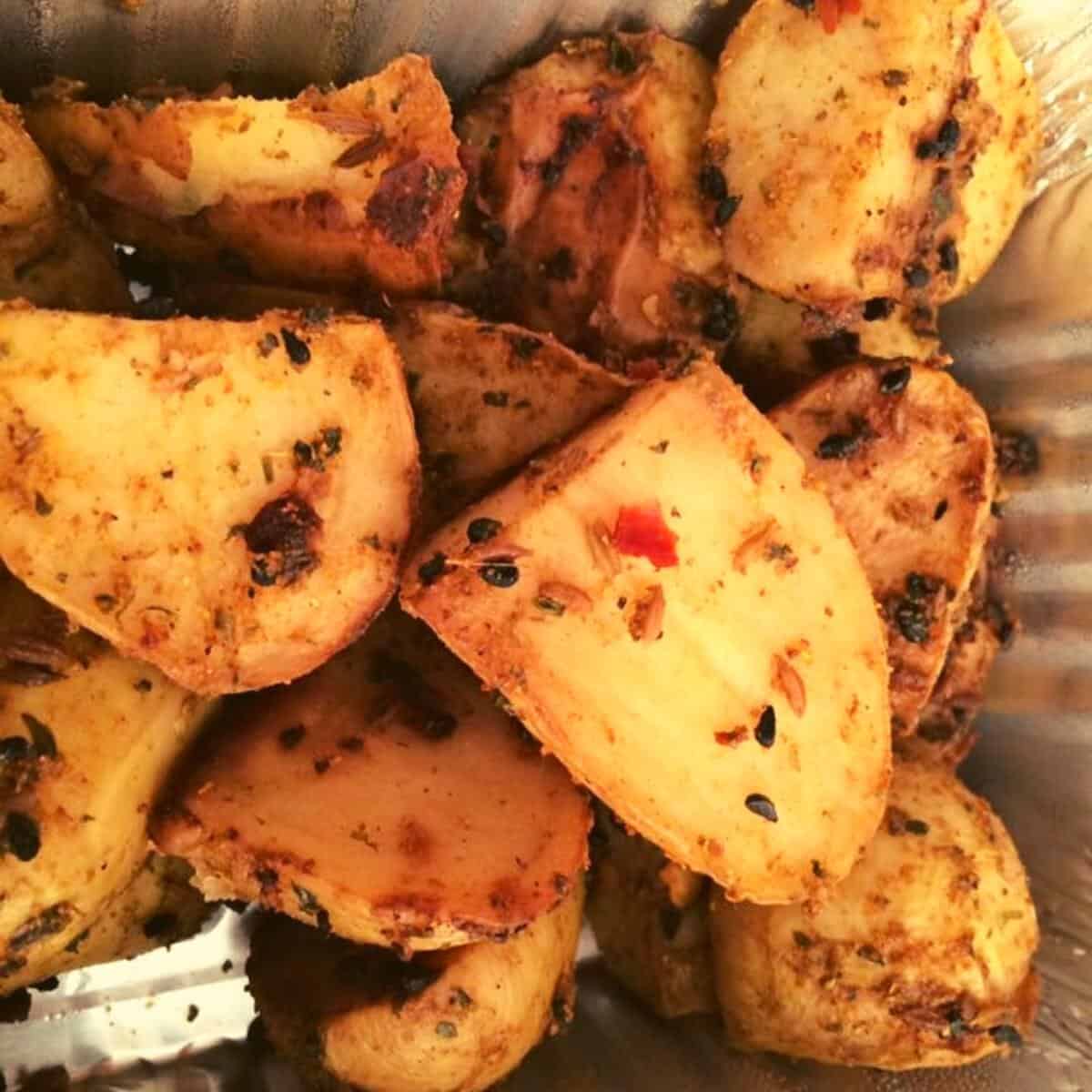 spicy potatoes in a foil tray