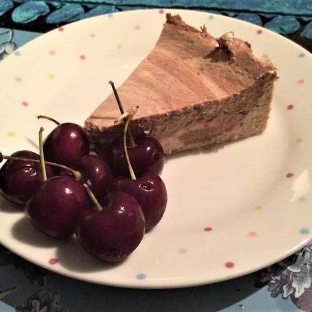 chocolate and coffee cheesecake served with fresh cherries on slimming world