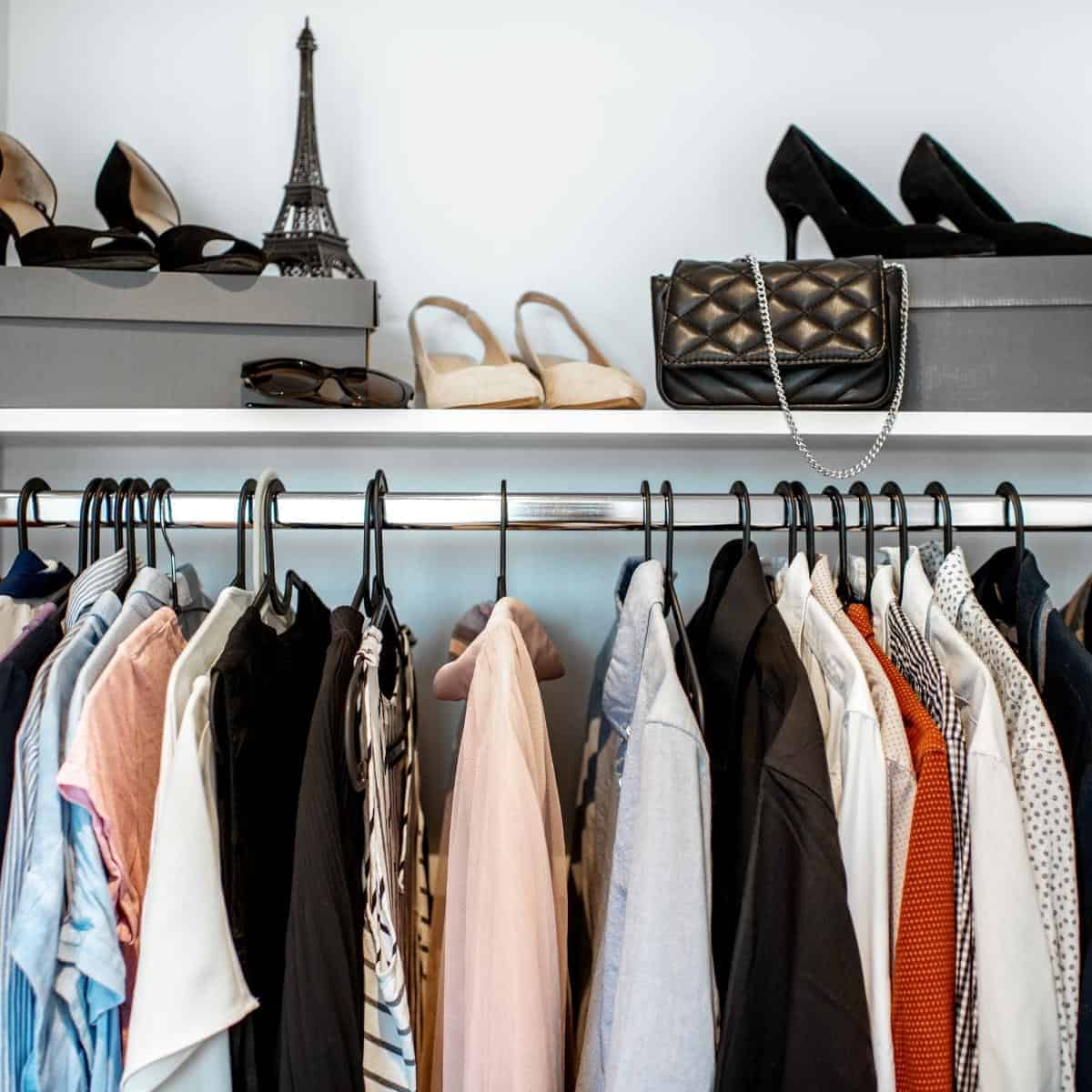 Tidy wardrobe with clothes and shoes.