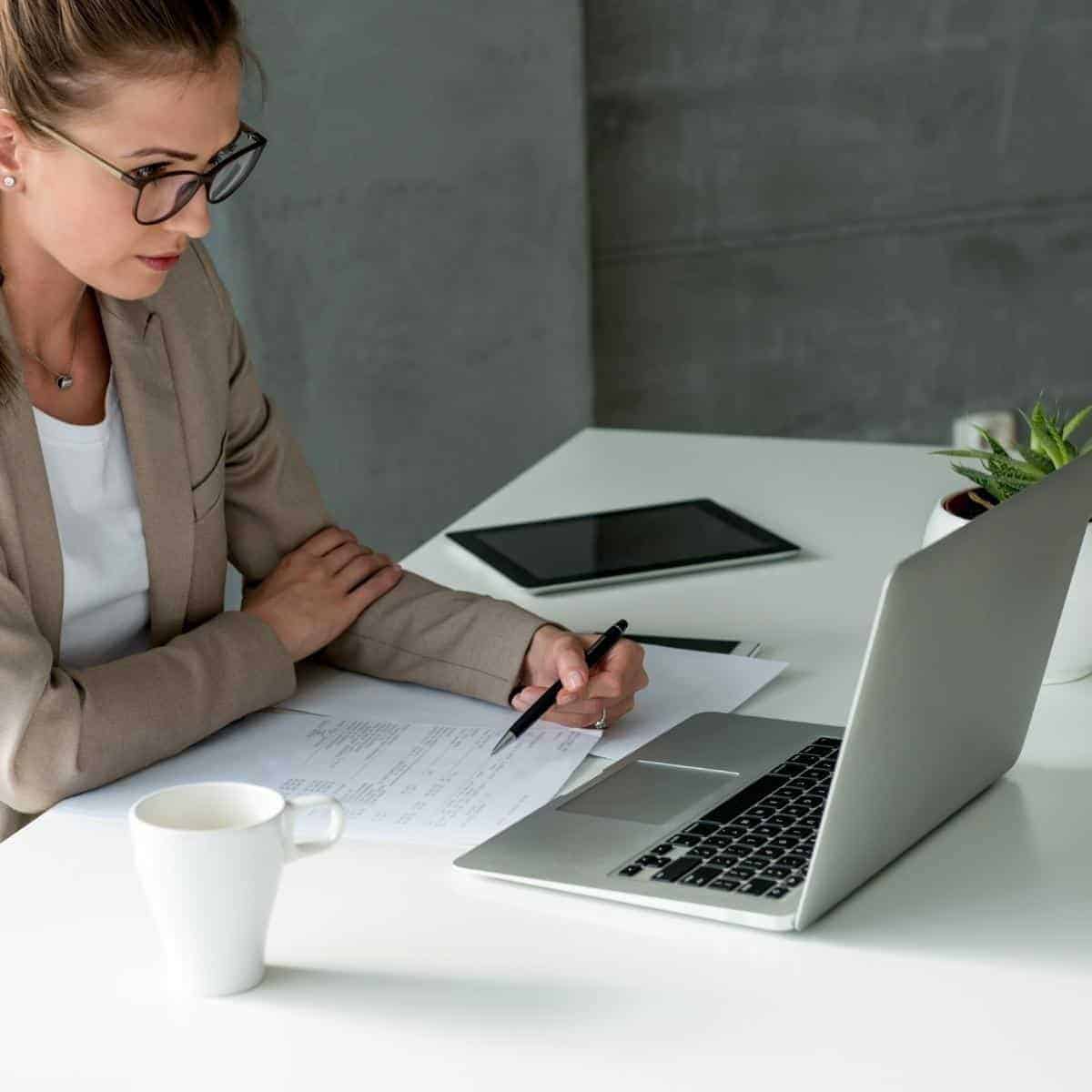 Lady at a desk at home working on a laptop