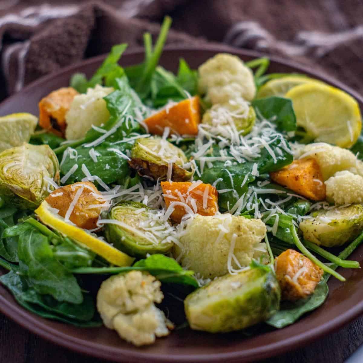 brown plate with roasted vegetable salad