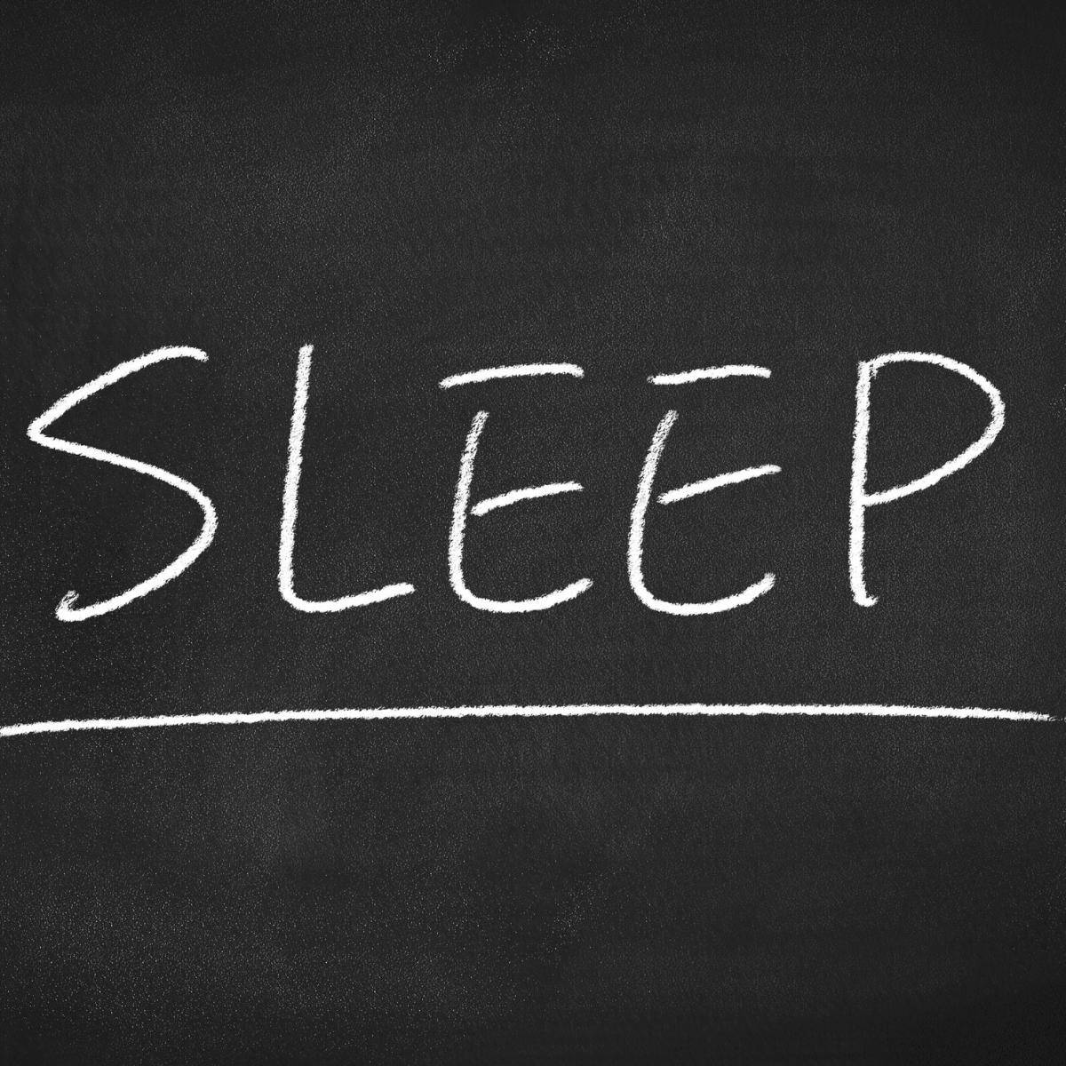 sleep written in chalk on a blackboard