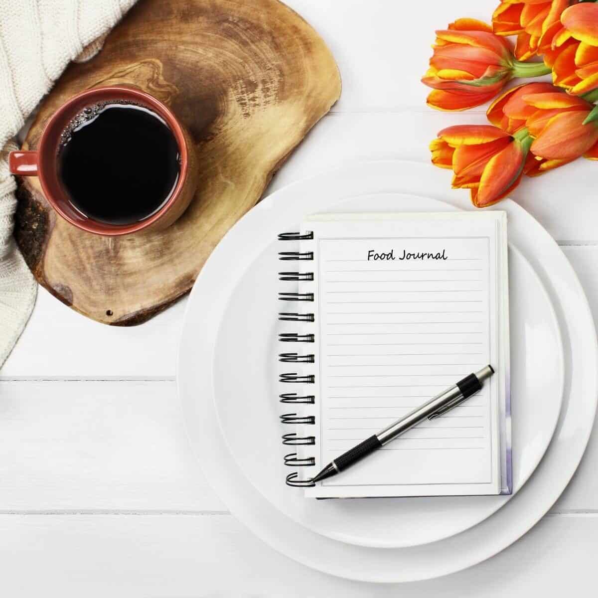 food diary with black coffee and tulips