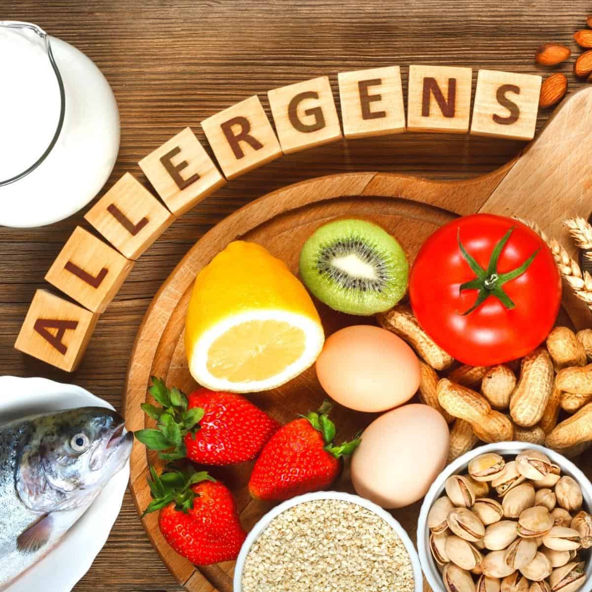 allergens written in wooden letter blocks surrounded by foods that are common allergens.