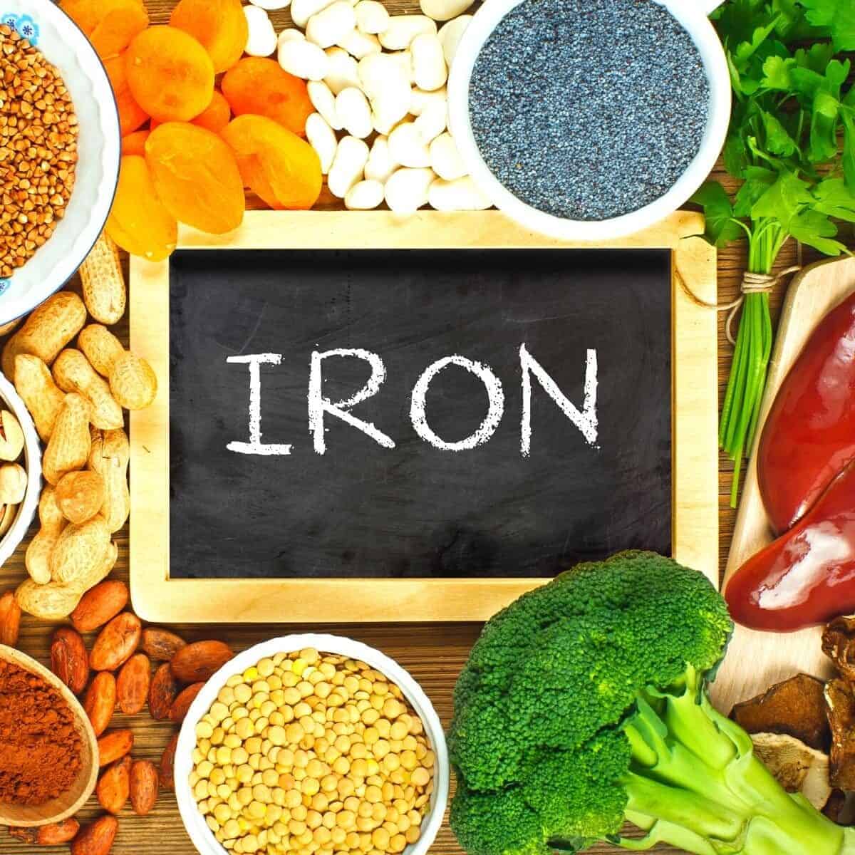 iron written on chalk board surrounded by iron rich foods