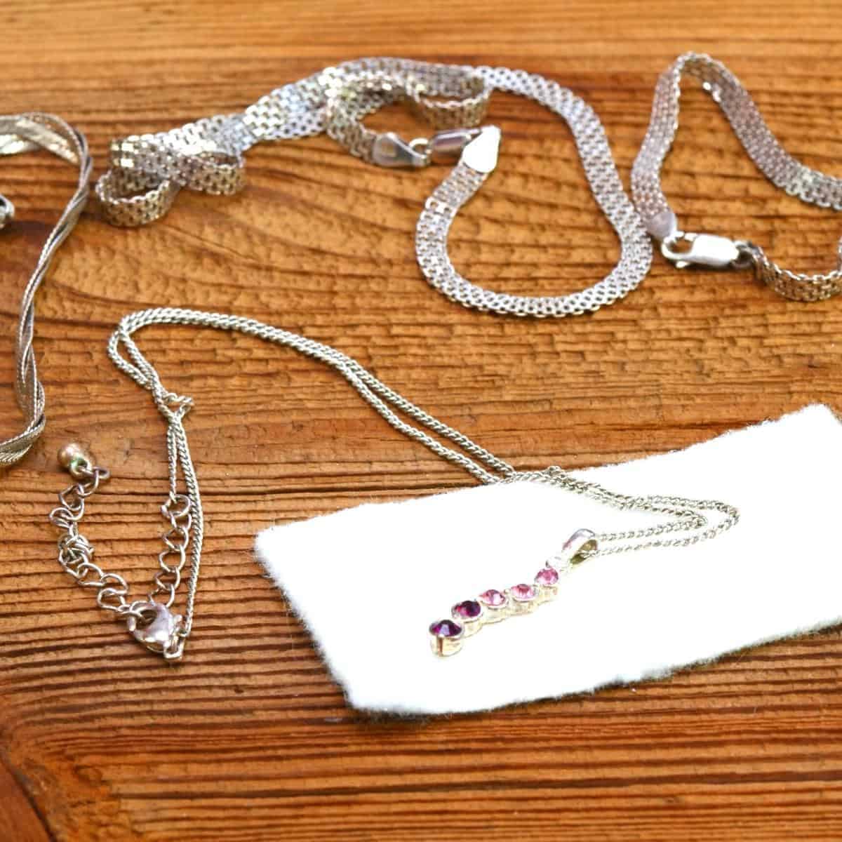 silver jewellery on a wooden table.