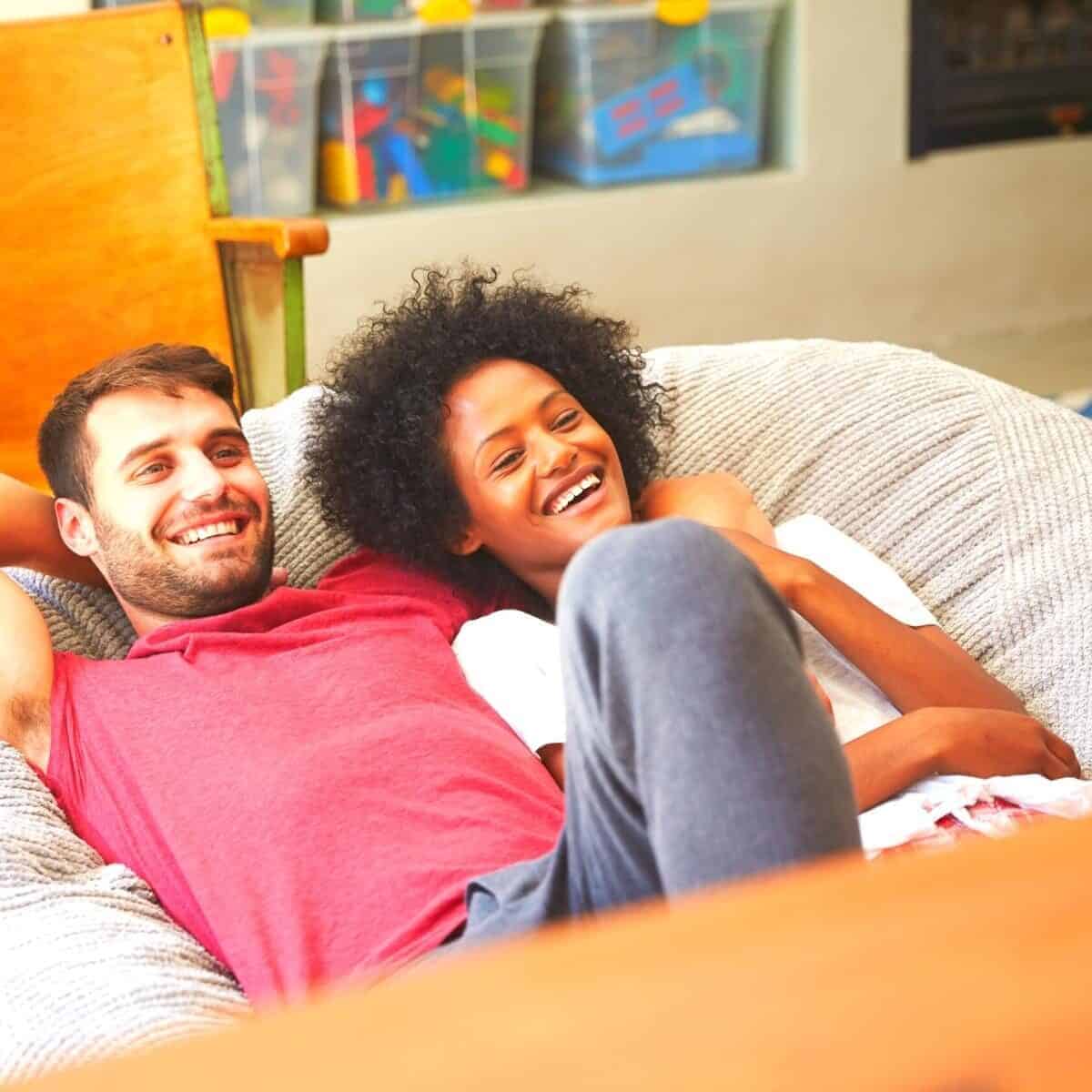 couple chilling on the sofa watching netflix or similar