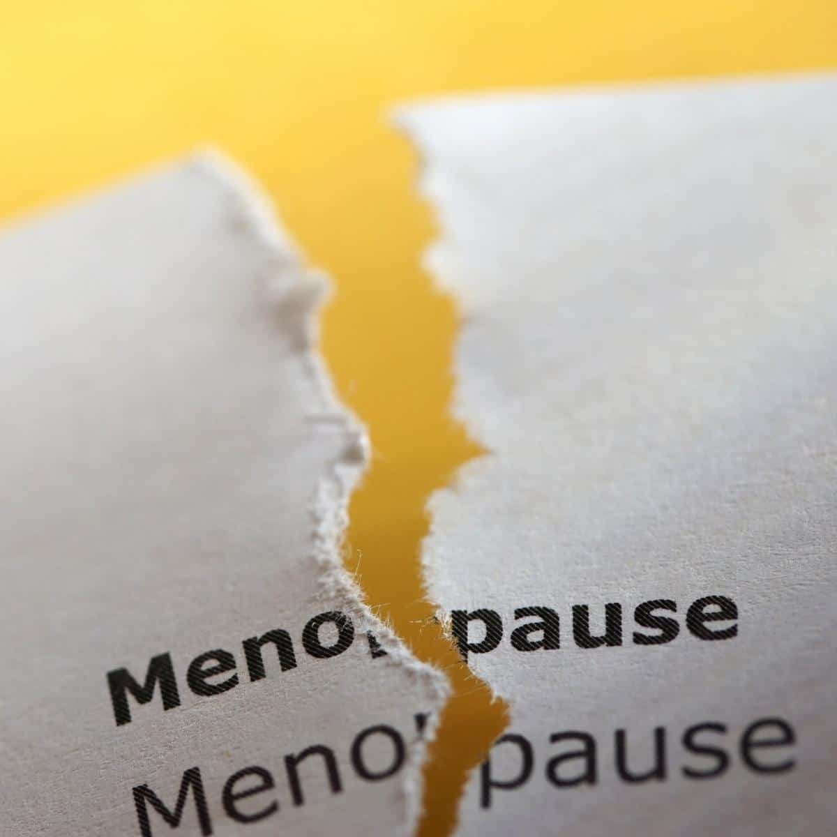 menopause on typed paper torn down the middle with yellow background