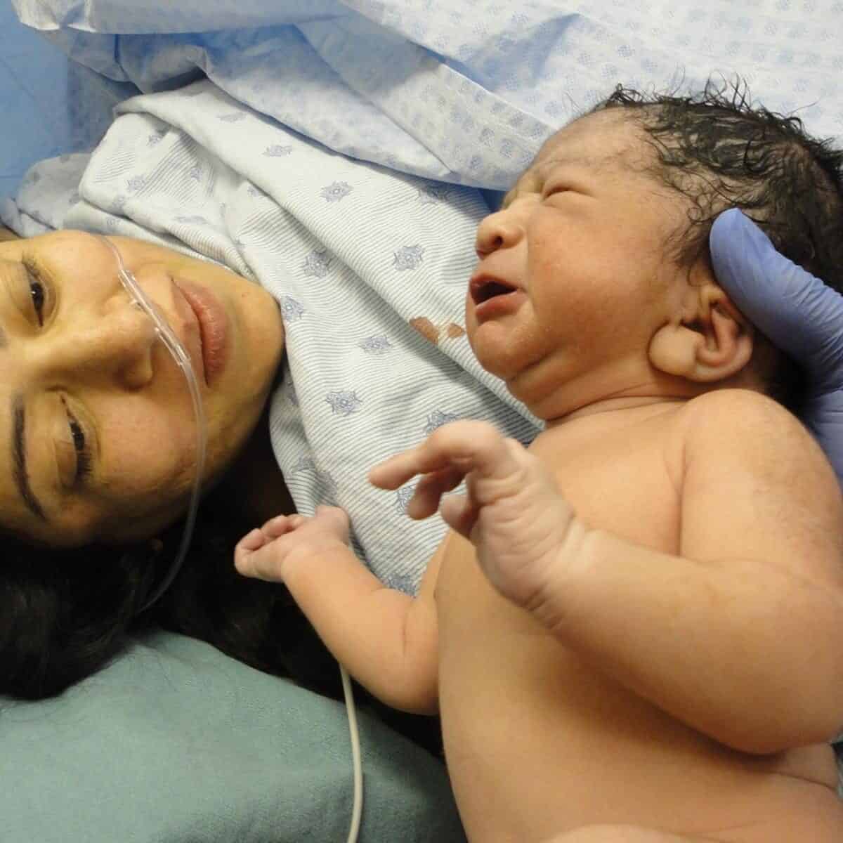Newborn baby with mother just after a c section birth