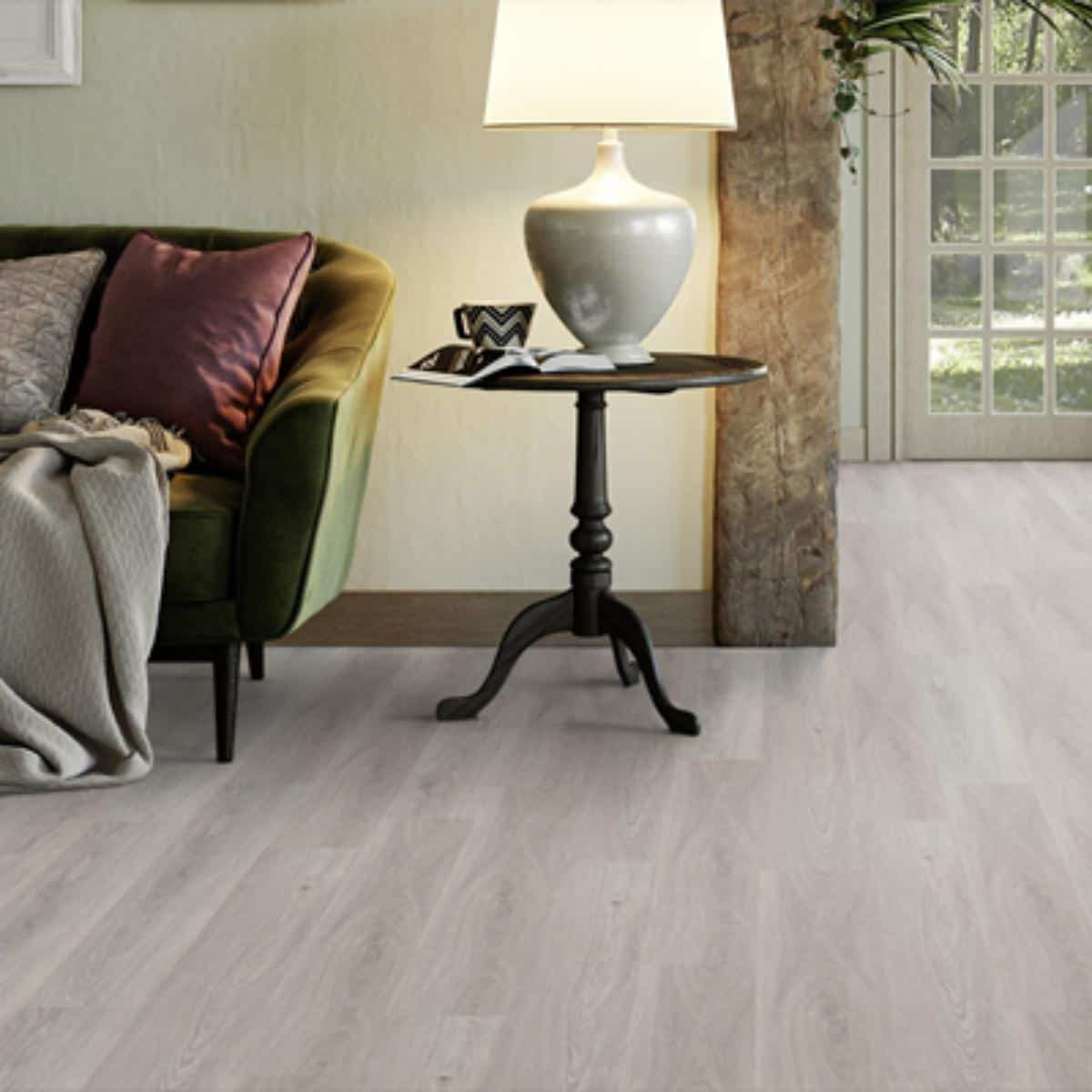 lounge with grey flooring and a sofa and side table.