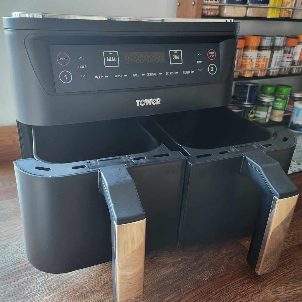 twin drawer air fryer with drawers open on wooden work surface