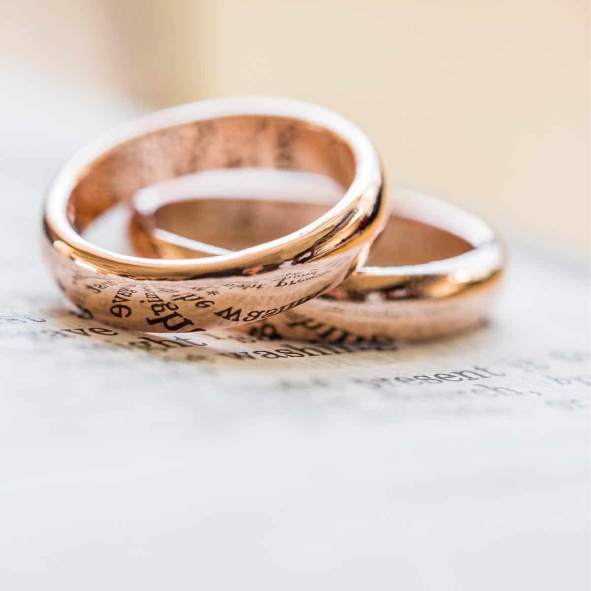 two gold rings on a book