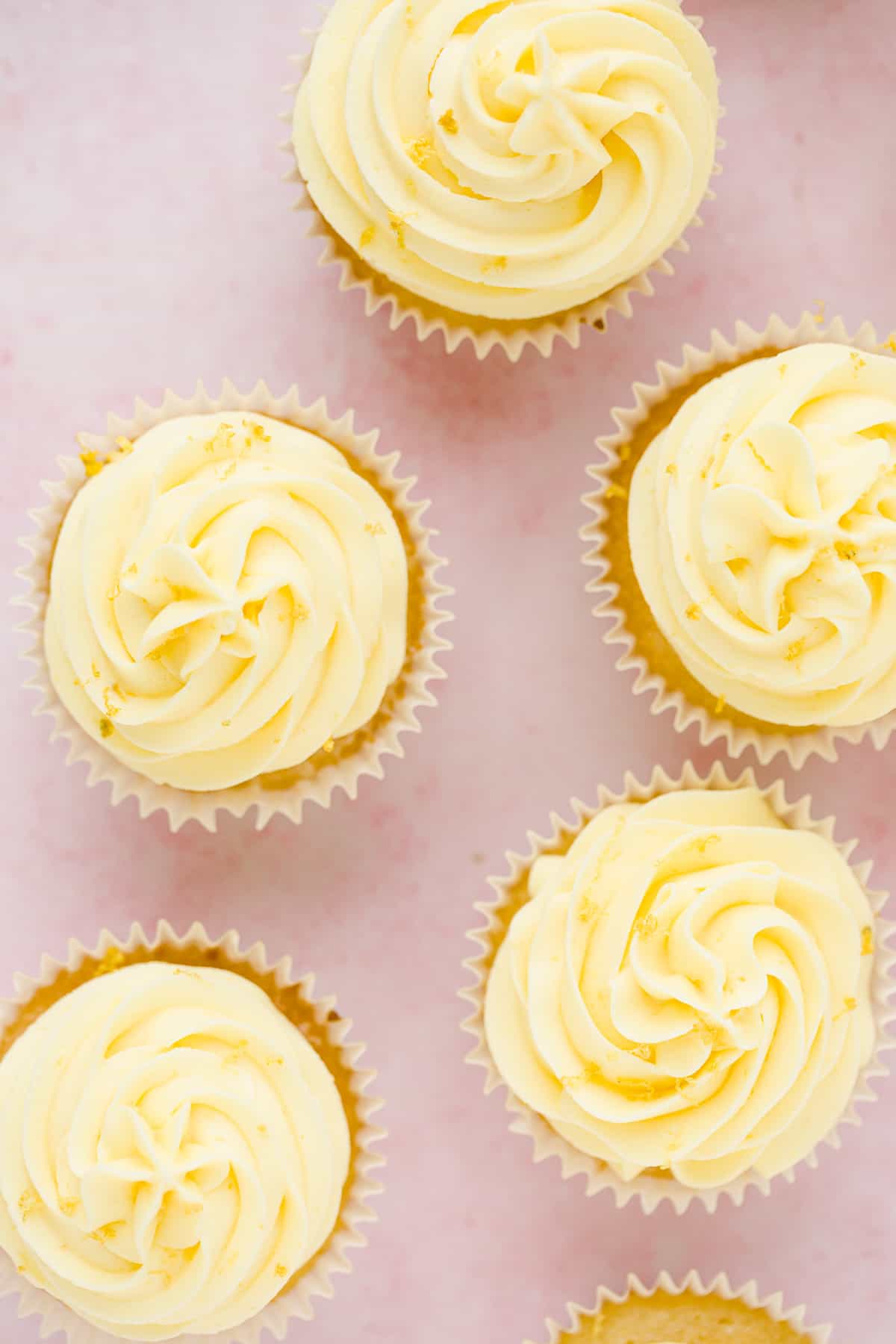 Overhead view of zesty moist lemon drizzle cupcakes.