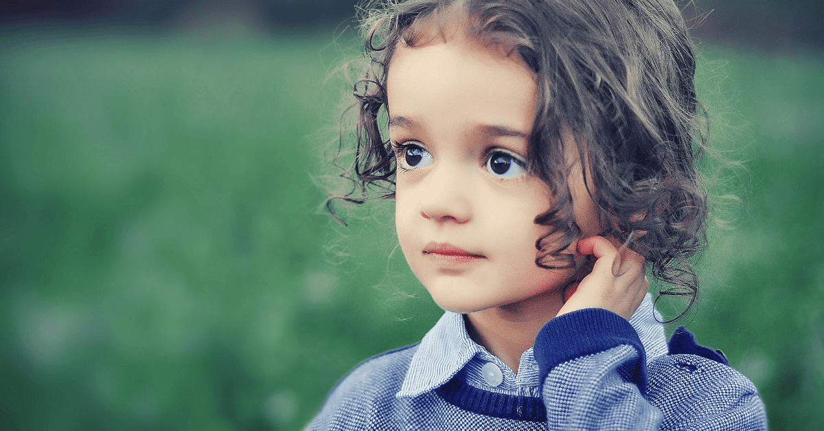 a small child touching their hair