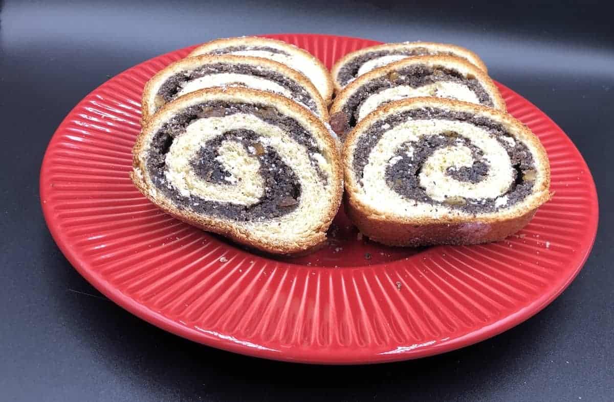 Makowiec Roll in a red plate.