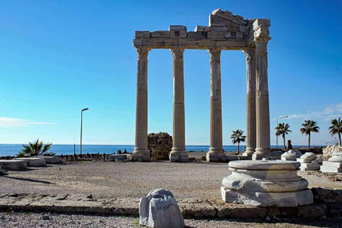 Remnants of antique Apollon Temple consisting of several columns with capitals at the Medirranean coast.