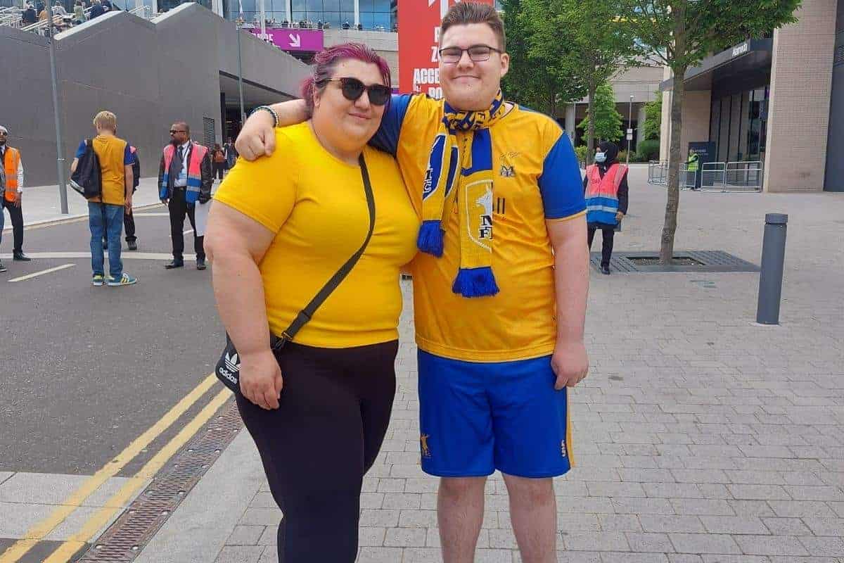 lady and young man in football clothes on Wembley way