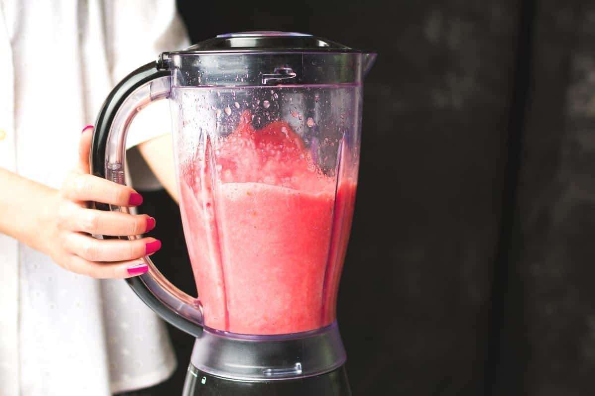 Blender with cranberry smoothie inside