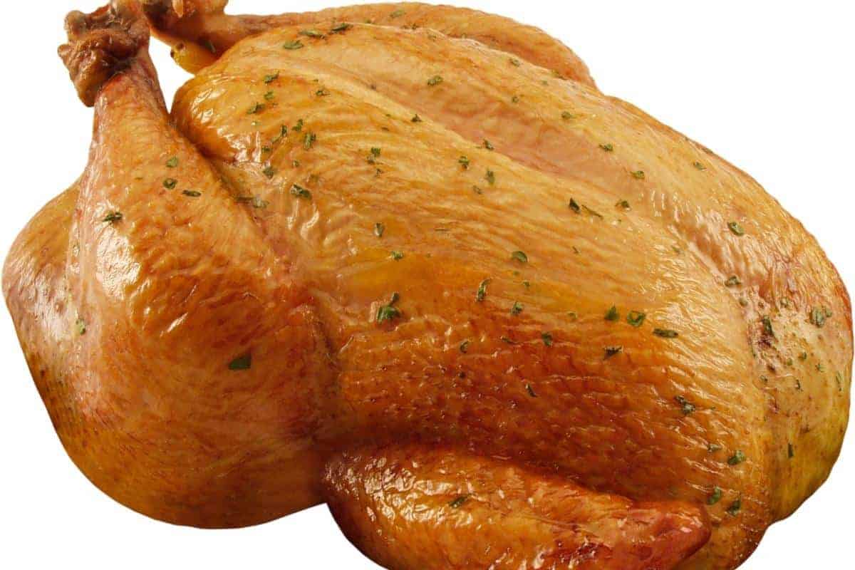 Whole roast chicken on white background