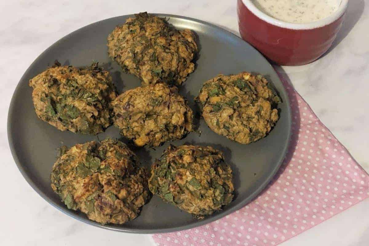 Falafel balls on a grey plate.