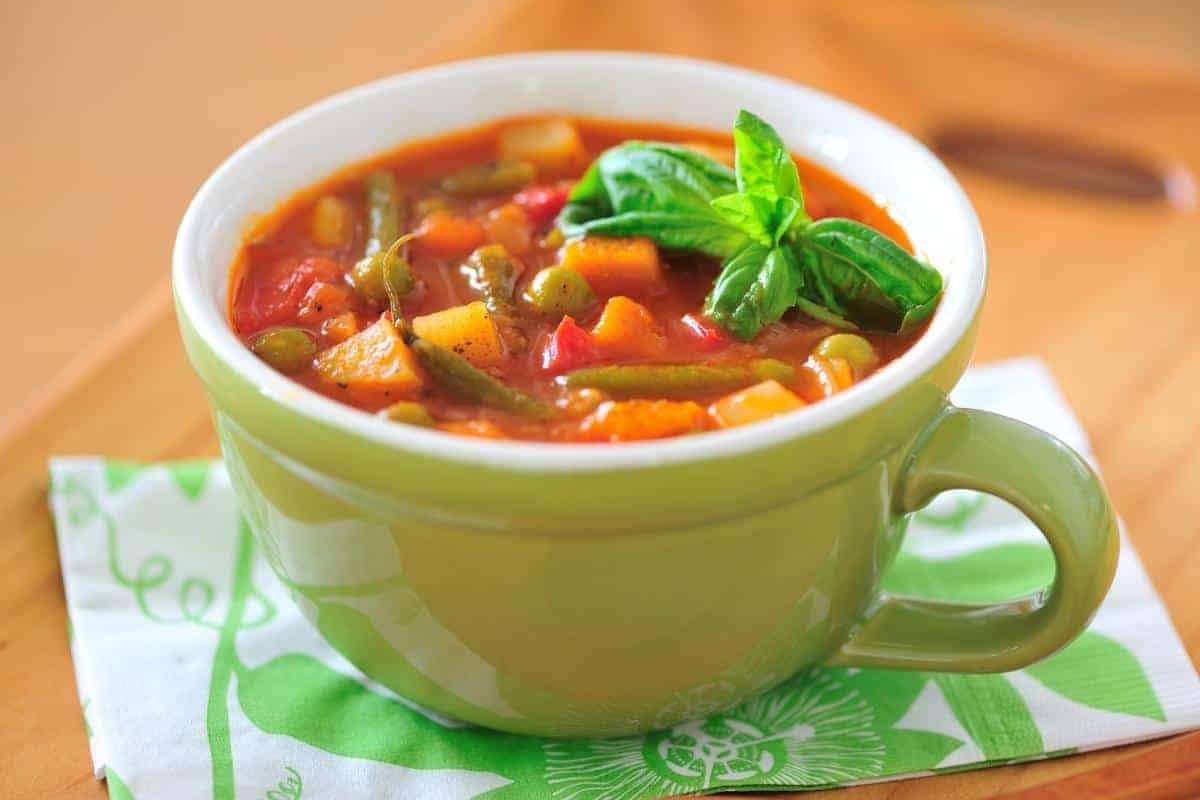 Minestrone soup in a green mug