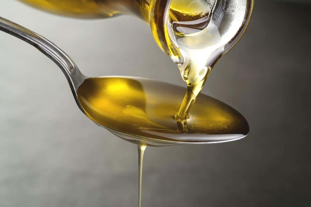 spoonful of oil being poured