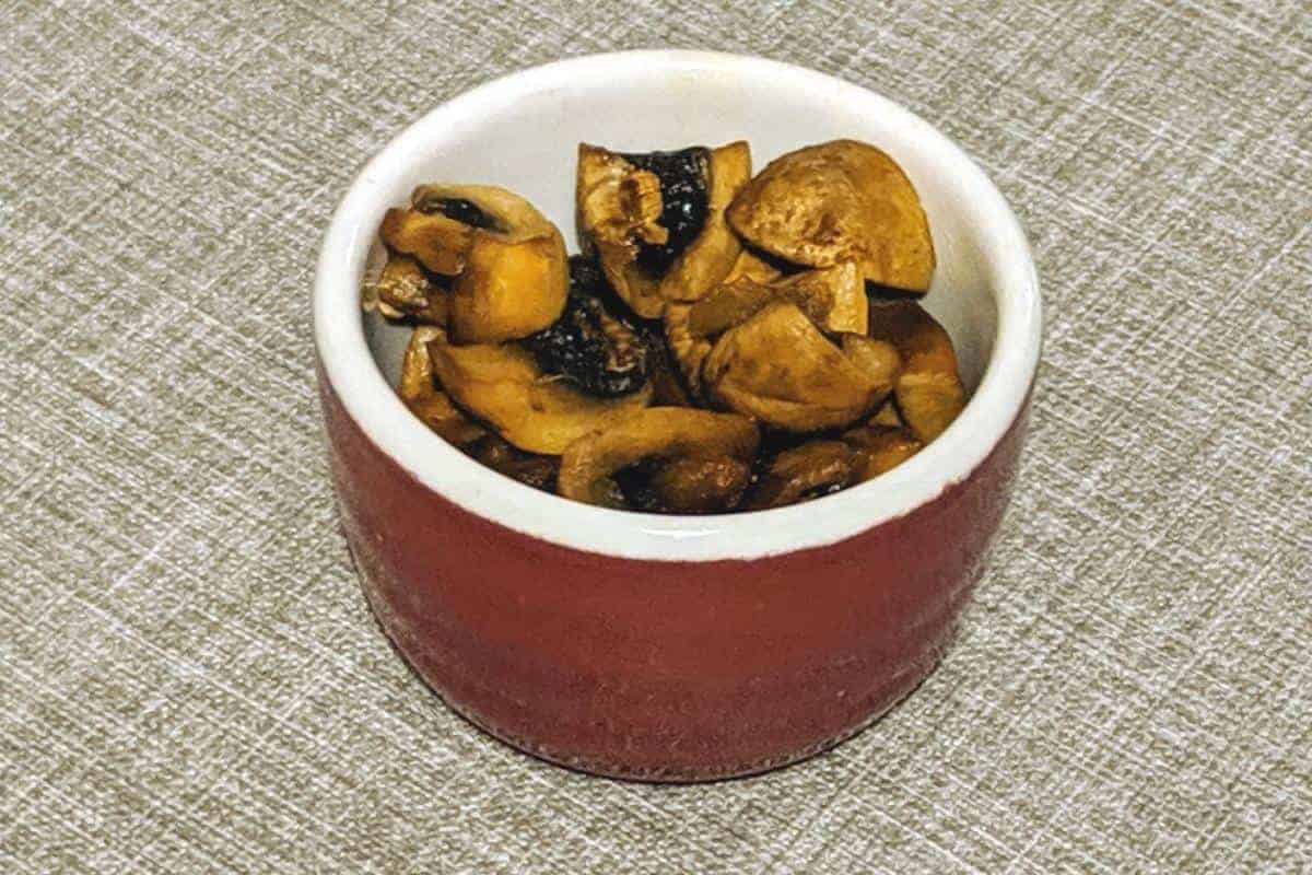 sticky mushrooms in red ramekin