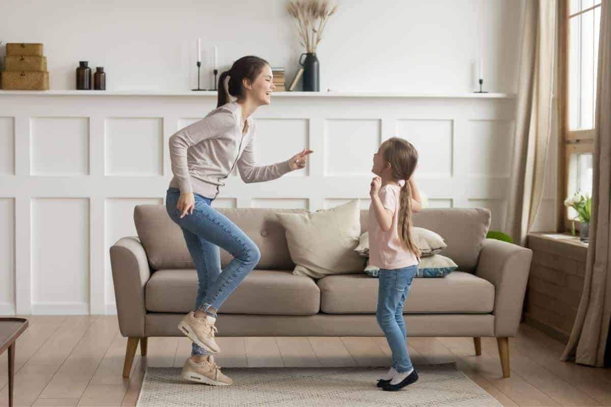 child and woman dancing in a lounge