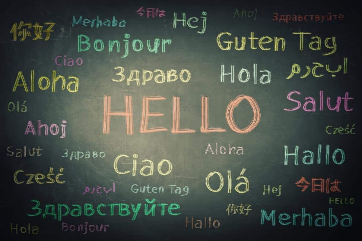 The word "hello" is written in various languages on a chalkboard background, when you find a language teacher or Japanese tutor you will learn more!