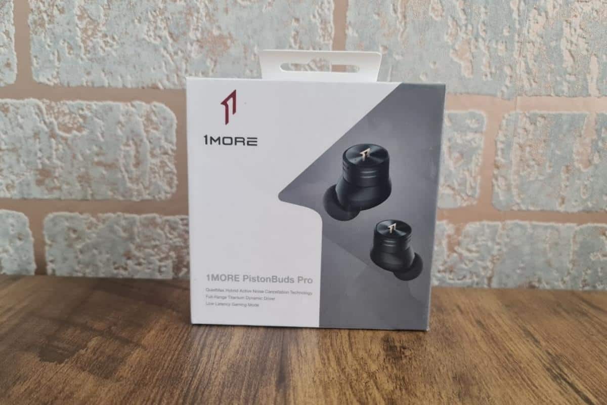 1 more piston buds earphones in box on wooden table