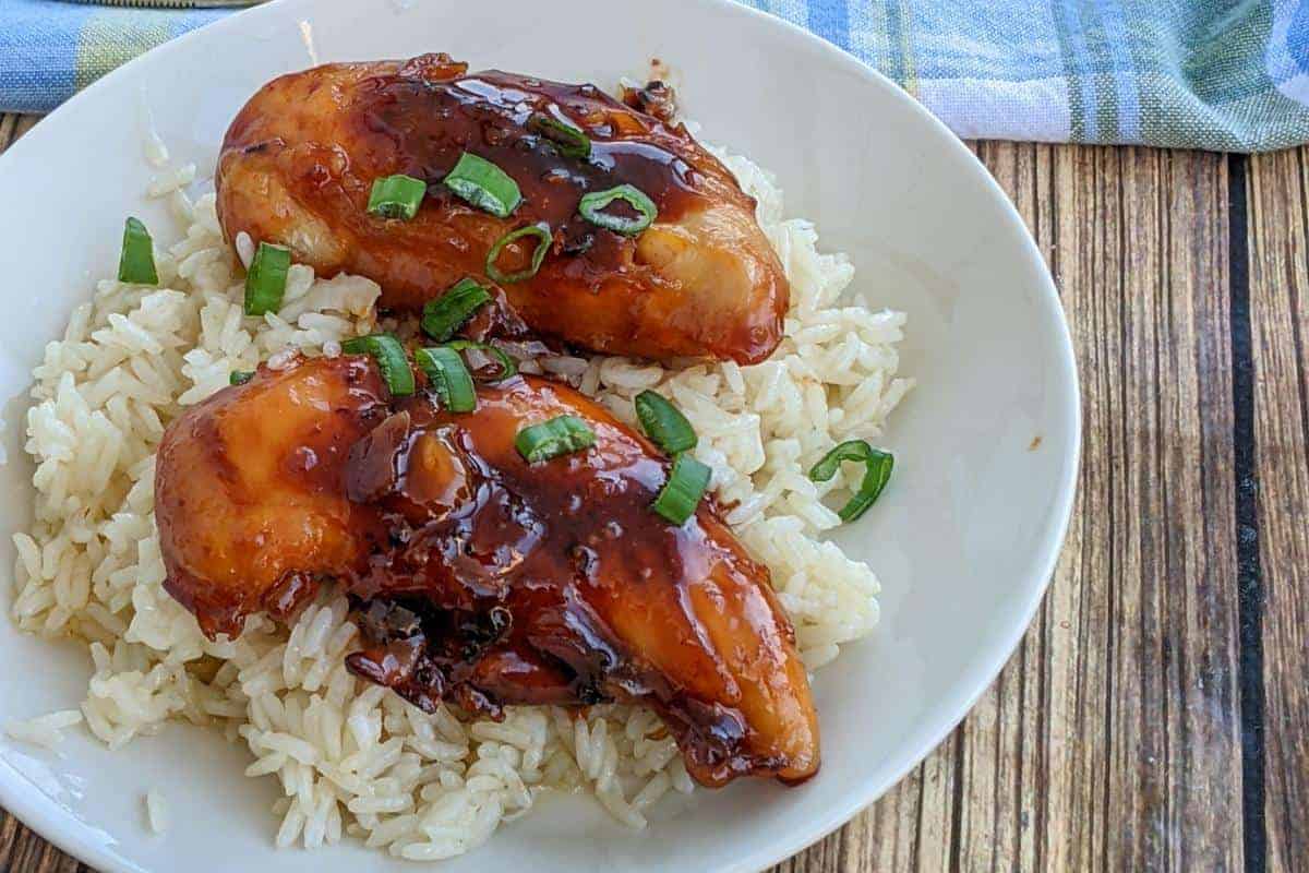 close up of the brown sugar garlic chicken on a plate with rice