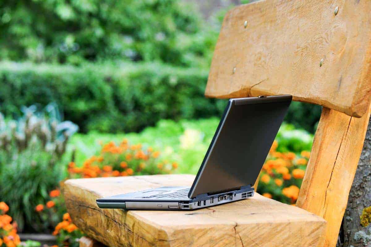 laptop on a bench outside