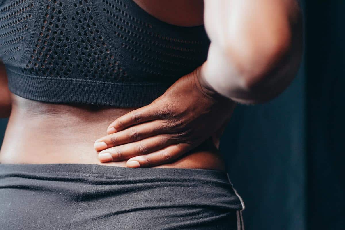 ladies hand on back with lower back pain